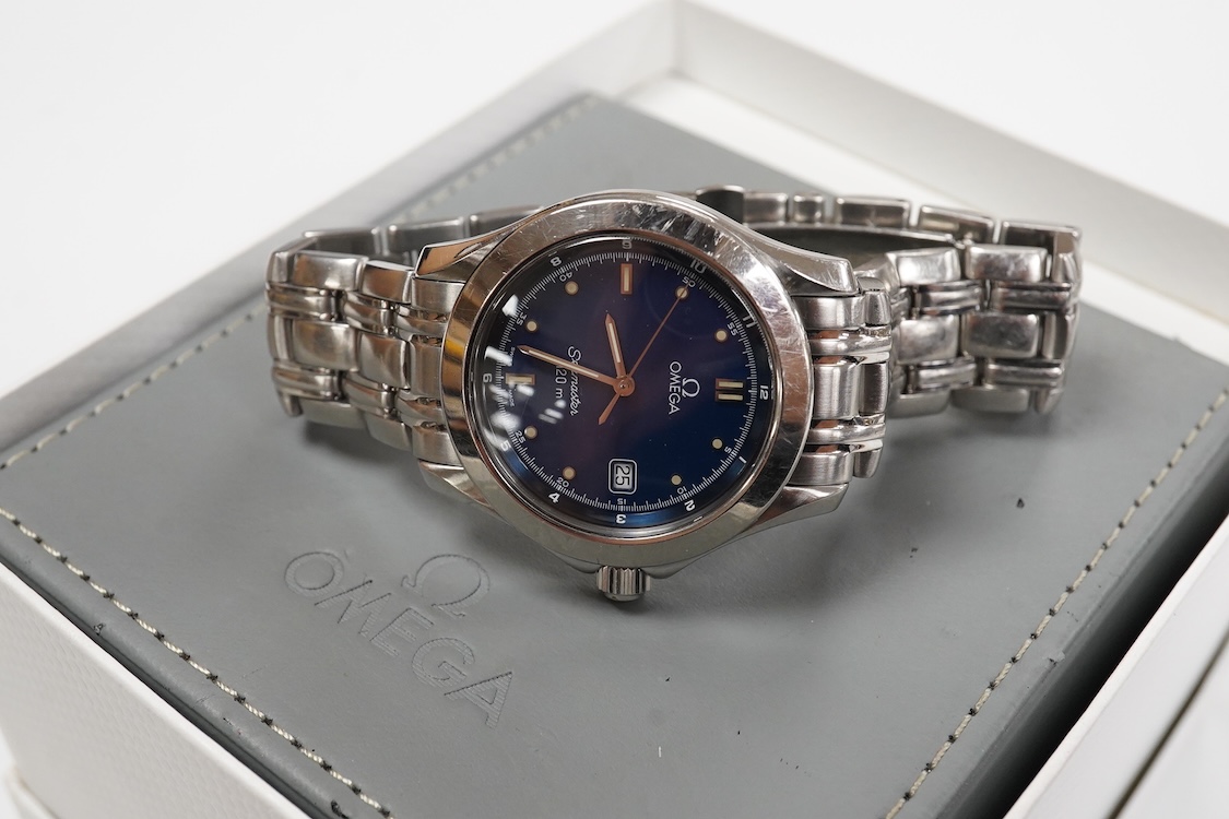 A gentleman's 1990's stainless steel Omega Seamaster quartz wrist watch, with blue dial dot markers and date aperture, case diameter 36mm, on a stainless steel Omega bracelet, with box and papers.